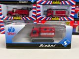 a red toy truck in a box on a table