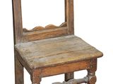 an old wooden chair sitting on top of a wooden table