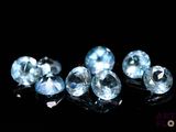 some very pretty blue diamonds on a black surface