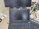 a laptop computer sitting on top of a desk next to a monitor
