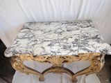 a marble top table with a gold frame on it