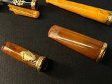 many different types of pens on a black table