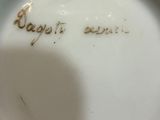 a white plate with writing on it in a persons hand