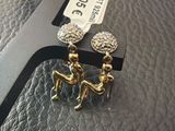 a pair of earrings that are sitting on top of a table