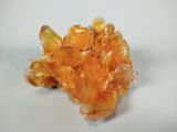 une image représentant un amas de cristaux orange posés sur une surface blanche