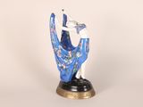 figurine of a woman in a blue dress holding a fan