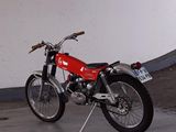 a red motorcycle that is parked in a parking garage