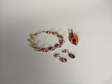 a picture of a bracelet and earring set on a table