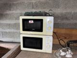 two microwaves sitting on top of each other on a counter