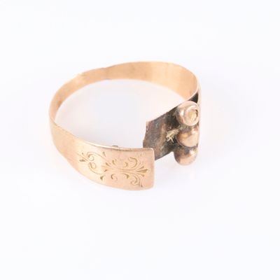 a close up of a gold ring on a white surface
