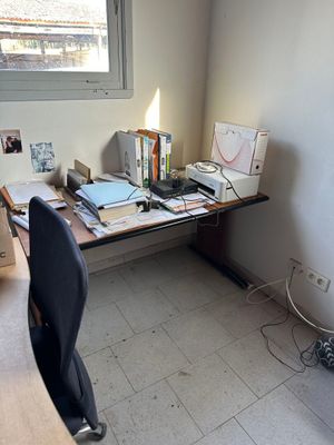 a desk with a chair and a computer on it