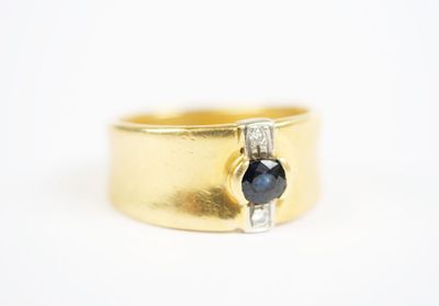 an image of a gold ring with a sapphire stone
