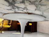 a white table with a marble top in the middle of a room