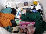 a white bag filled with clothes and a stuffed animal