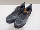 a pair of grey and orange sneakers sitting on top of a white table