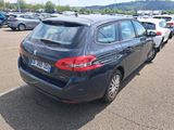 a black car parked in a parking lot next to other cars
