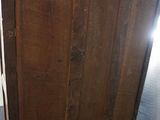 a wooden cabinet with a door on top of it