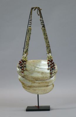 an image of a white and brown bag on a stand