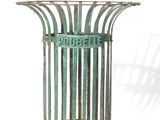a metal trash can with a green sign on it