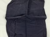 an image of a piece of black cloth on top of a white sheet