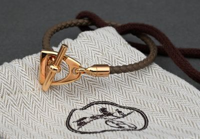 a gold bracelet with a horse head on it