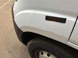 a close up of a white truck with a sticker on it ' s side