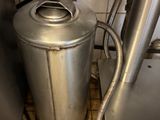 a metal container with a hose attached to it in a kitchen