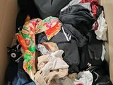 a cardboard box filled with clothes and other items