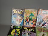 a lot of comic books sitting on a table