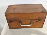 a small wooden box with a handle on a table