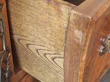 a close up of a wooden drawer with a chain on it