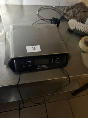 une photo d'un plan de travail de cuisine sur lequel se trouvent un ordinateur portable et un rouleau de papier toilette