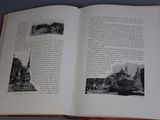an open book with a picture of a city in it