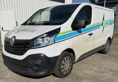 a white van with a blue and green stripe parked in front of a building