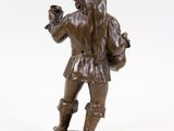 bronze figurine of a man holding a cup of coffee