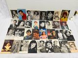 a lot of old photos of people on a bed