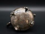 a close up of a silver object on a black surface