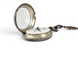 a silver pocket watch with a chain around it and a magnifying glass
