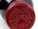 a wine bottle that has a red seal on it