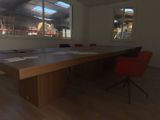an image of a conference room with a table and red chairs