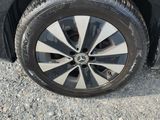 the tire of a car with a flat tire on a gravel road