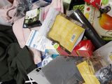 a pile of clothes and other items in a trash can