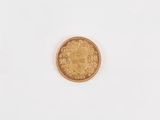 a gold coin on a white surface with a white background