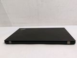 a black laptop sitting on a white surface