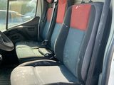 many seats in the back of a van that are empty