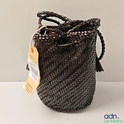 a basket with a tag on it sitting on a table