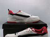 a pair of white and red sneakers on a black box