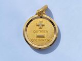 une pièce d'or sur laquelle est gravée une croix, sur un fond bleu