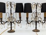 three lamps that are on a table with black lampshads