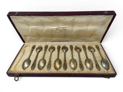 six spoons in a case on a white surface